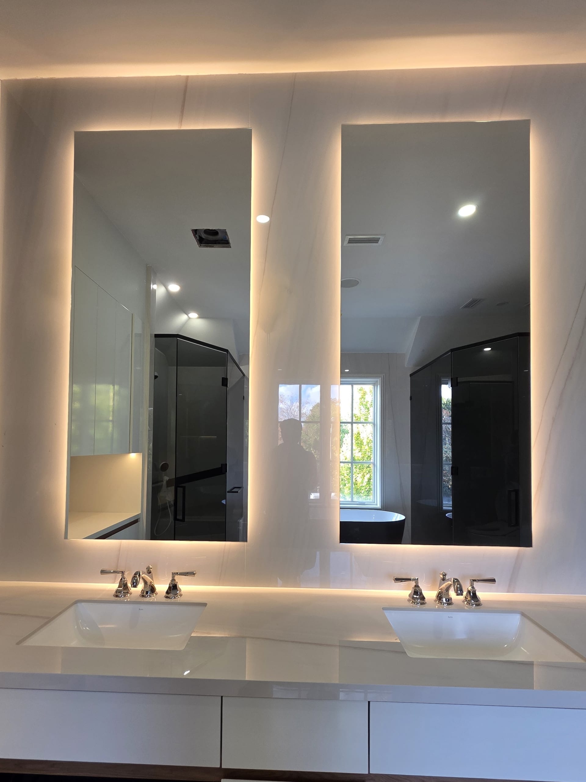 Custom LED backlit vanity mirror with halo surround in luxury bathroom — Built By Glass, GTA