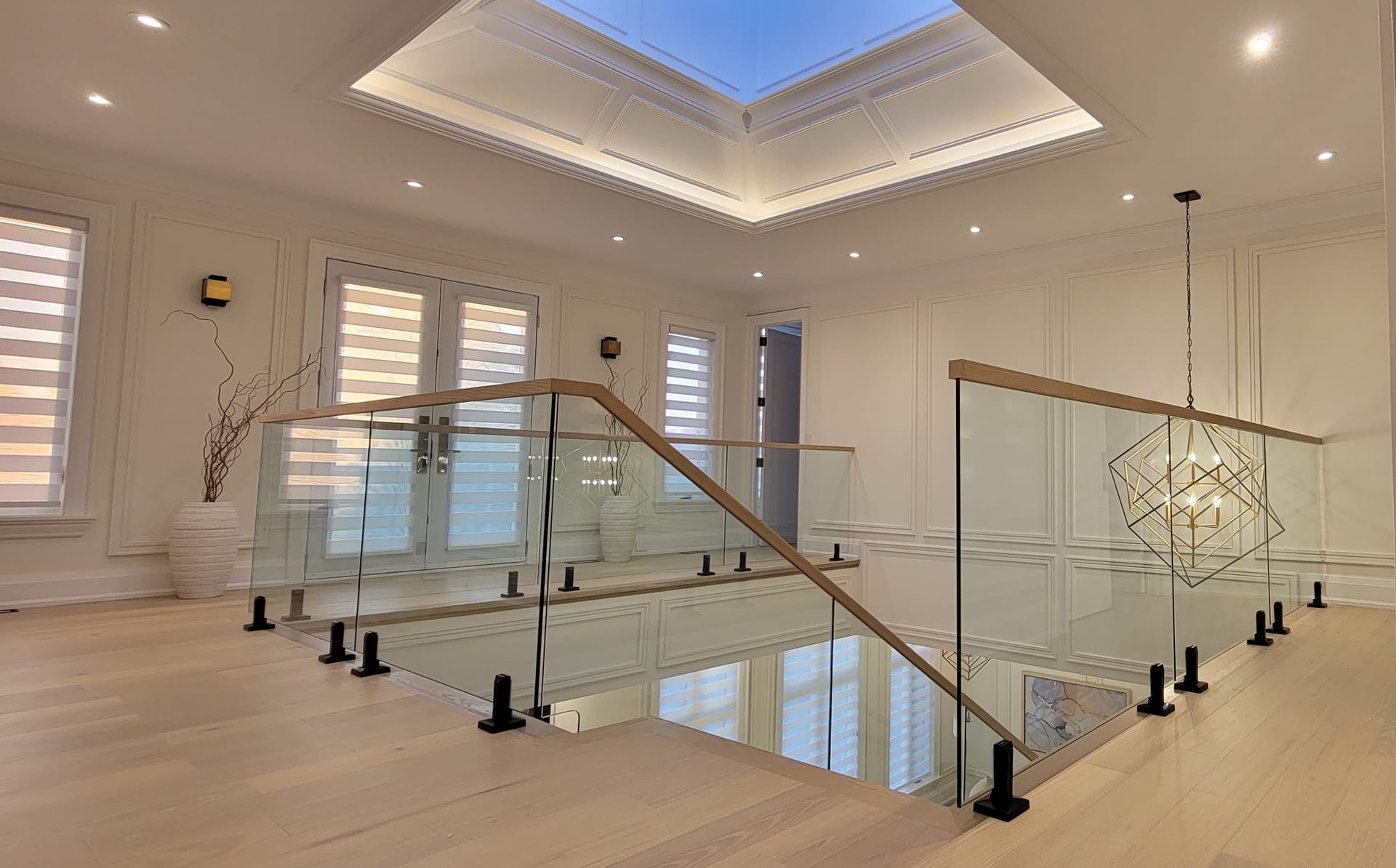 Precision glass railing installation on a modern open-tread staircase — Built By Glass